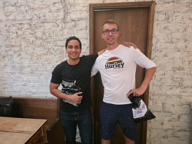 Diverse young adults learning languages together in a vibrant café, enjoying interactive classes and social connections at Olalingo Campus
